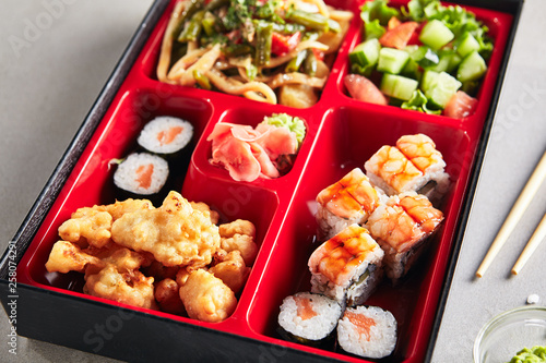 Fresh Food Portion in Japanese Bento Box with Sushi Rolls
