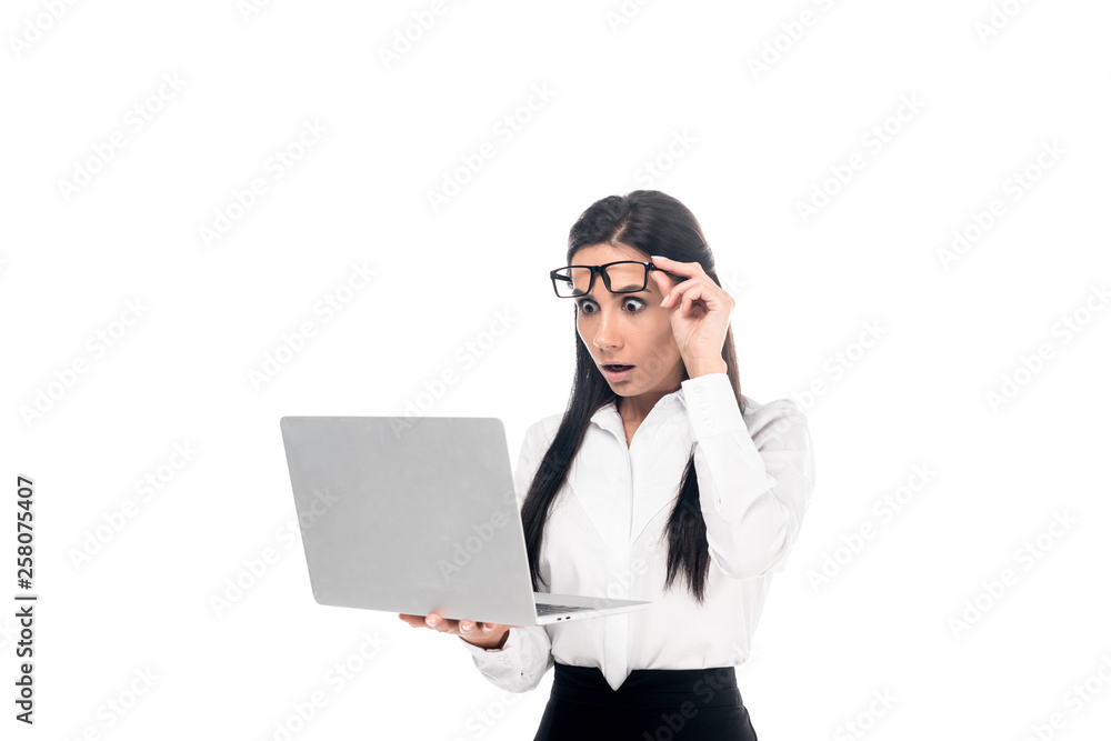 Shocked businesswoman in glasses using laptop isolated on white Shocked businesswoman in glasses using laptop isolated on white