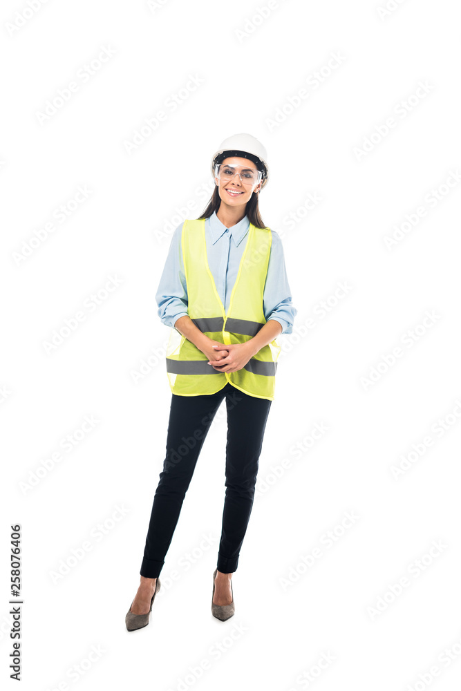 Full length view of smiling engineer in safety vest and hardhat isolated on white Full length view of smiling engineer in safety vest and hardhat isolated on white