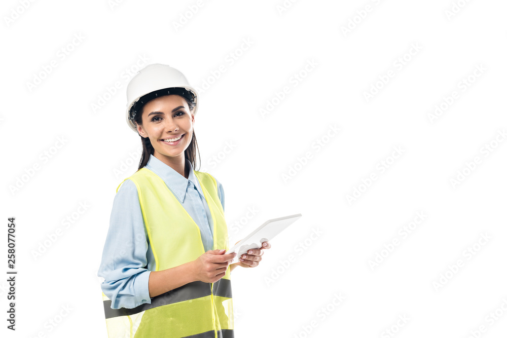 Engineer in safety vest using digital tablet isolated on white Engineer in safety vest using digital tablet isolated on white