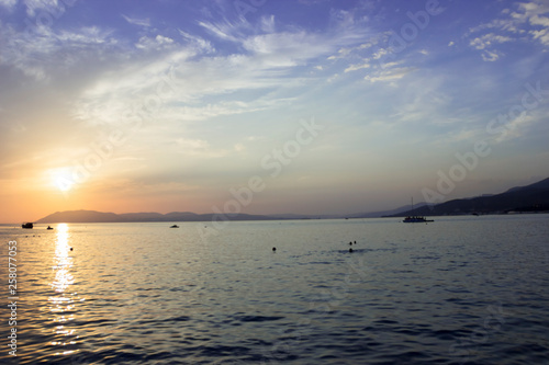 Bright sunset with large yellow sun under the sea surface, the image does not focus and blurred © Elena