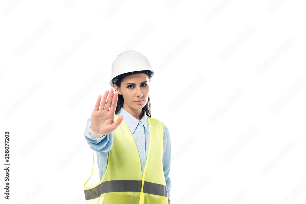 Strict engineer in hardhat showing stop sign isolated on white Strict engineer in hardhat showing stop sign isolated on white