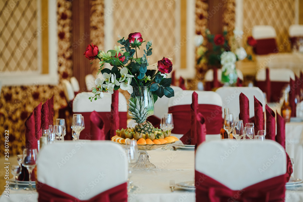 Table of fruit and crystal glasses arranged on a table. with red napkins. Table of fruit and crystal glasses arranged on a table. with red napkins.