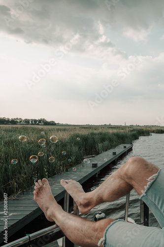 Sitting on a boat blowing bubbles