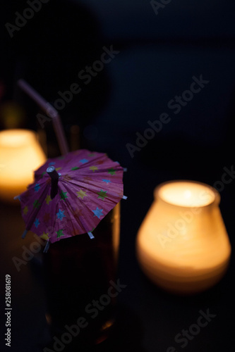 Romantic candle light drink with umbrella