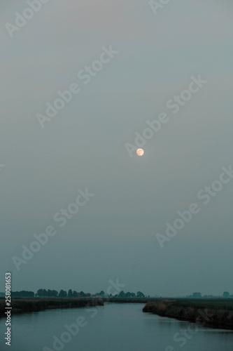 Moon above a river