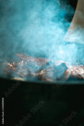 Meat and smoke on a grill
