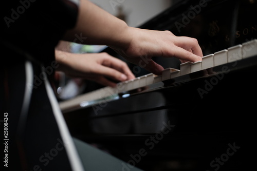 Beautiful woman playing piano, learn to play piano.