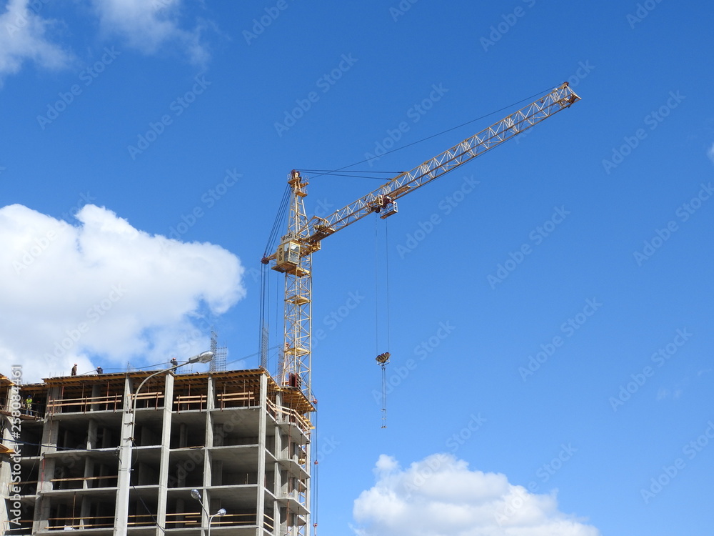 Tower cranes and their parts, construction of a new house.