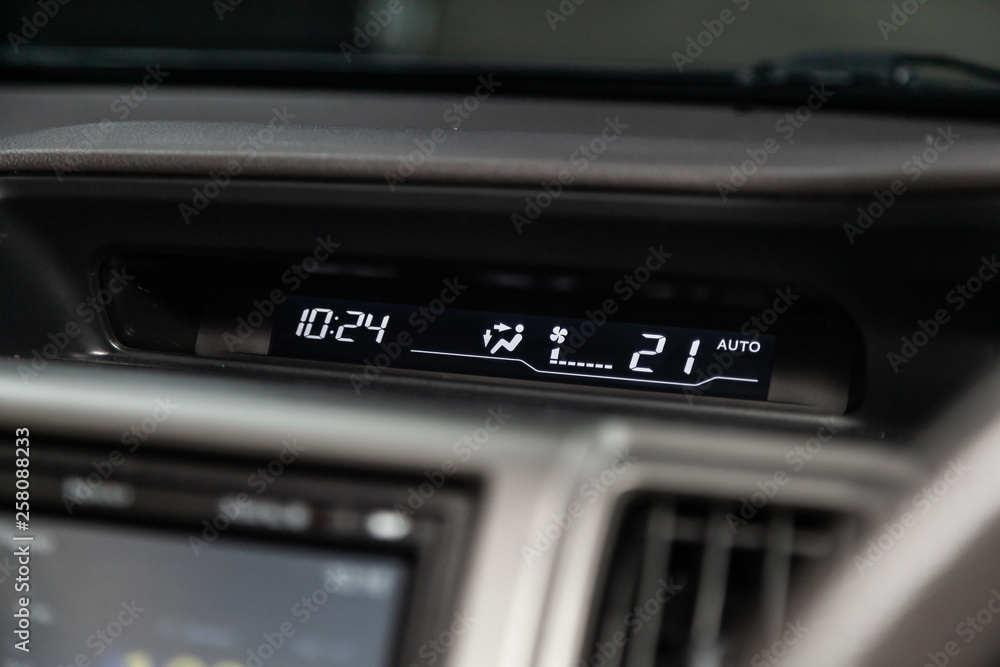 Сlose-up of the car  black interior:    dashboard with watch, temperature,monitor.