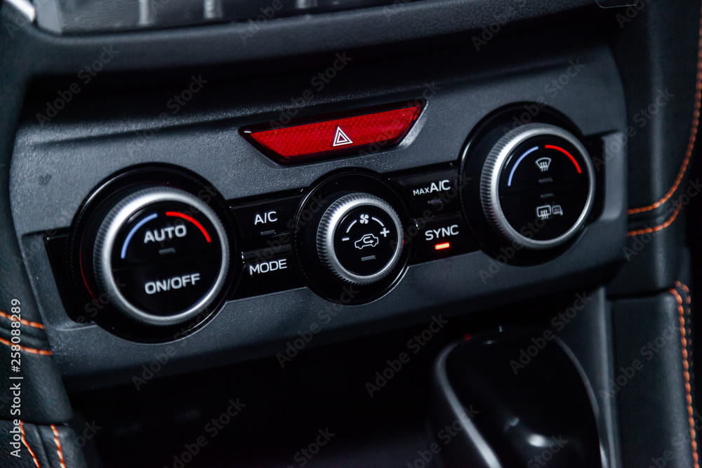 Сlose-up of the car black interior: dashboard, adjustment of the blower, air conditioner, player, accelerator handle and other buttons. Сlose-up of the car black interior: dashboard, adjustment of the blower, air conditioner, player, accelerator handle and other buttons.