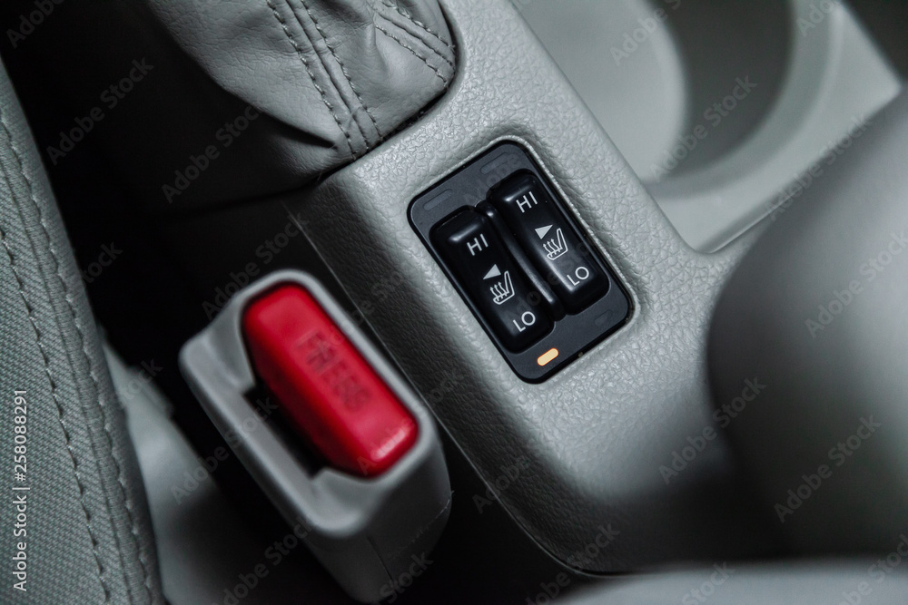 Сlose-up of the car  grey interior:  seat heatting buttons.