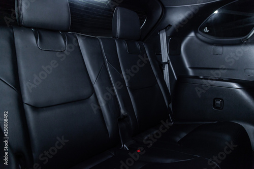 Сlose-up of the car  black interior:  black leather rear seats and seat belts . © Виталий Сова