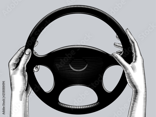 Woman's hands driving with steering wheel