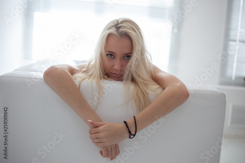 Amazing blond girl posing for photo in loft photo studio