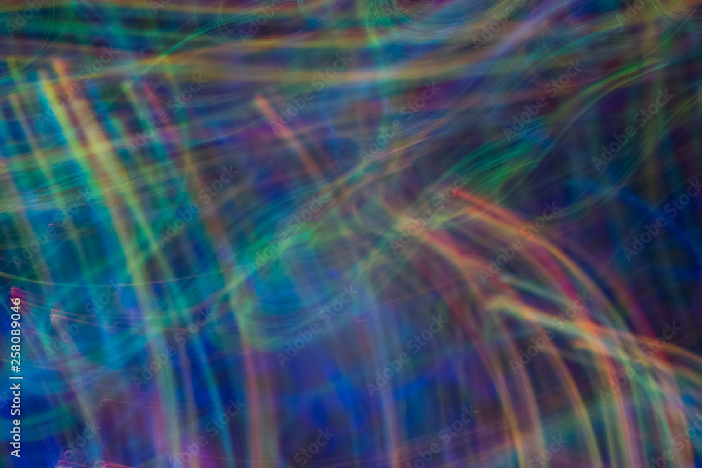Bokeh abstract background with multicolor blue lights in motion. Blur lens flare glow.