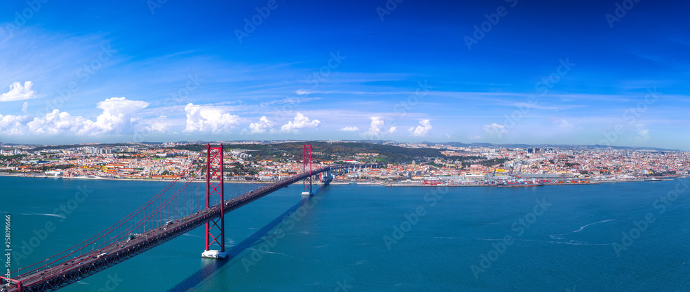 Fototapeta premium Summertime sunshine day panoramic cityscape view of Lisbon, Tagus river, Portugal.