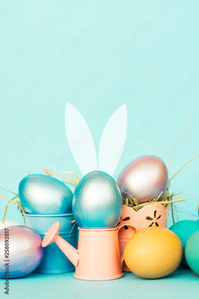 Easter eggs  in colored watering can, selective focus image, Card Happy Easter