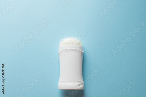 white deodorant on blue background. bath concept. place for text. copy space photo
