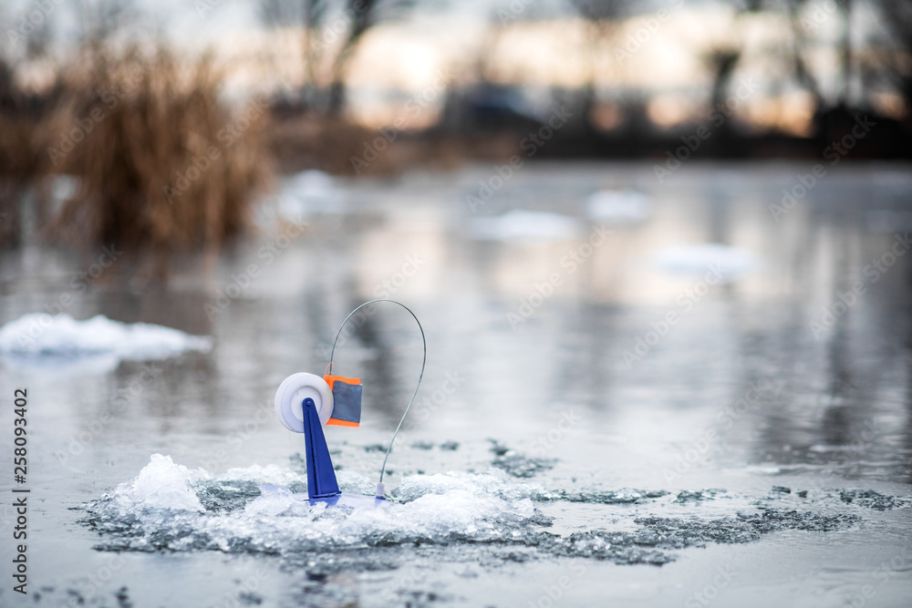 Naklejka premium Fishing tackle for winter fishing on the ice of a frozen lake
