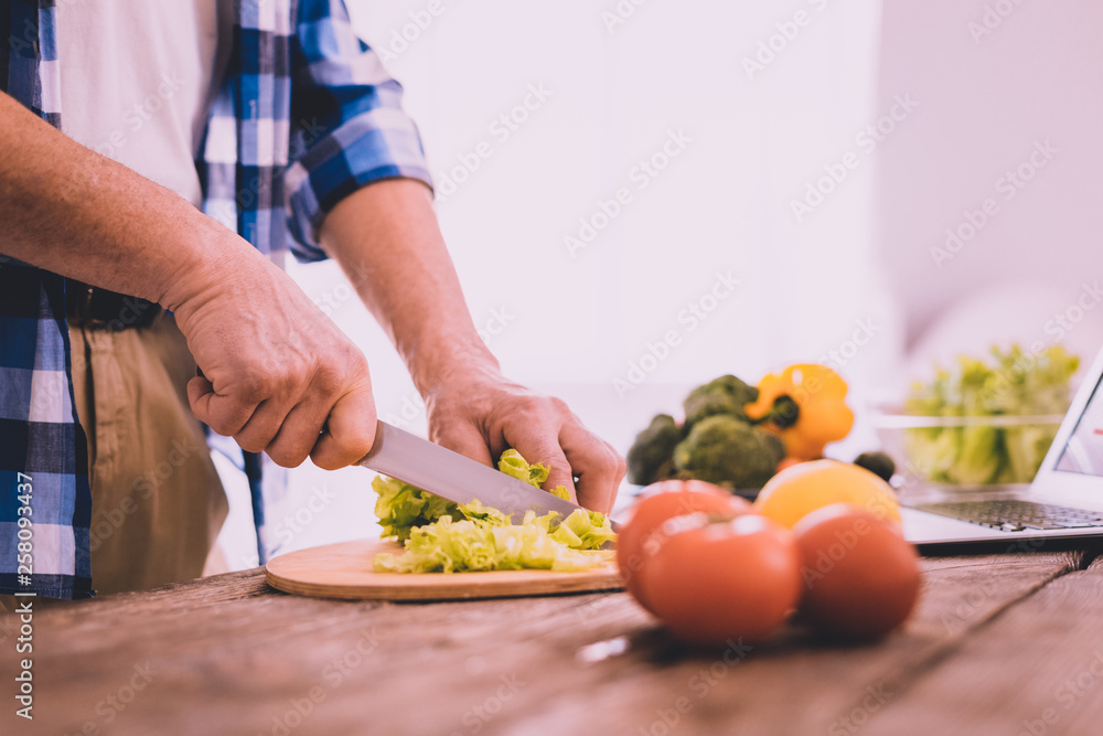 Confident man cooking lunch for the whole family