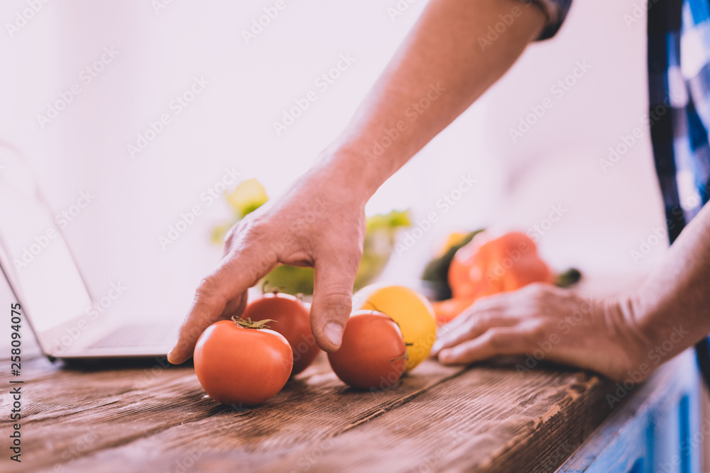 Motivated confident man choosing ingredients for a salad Motivated confident man choosing ingredients for a salad