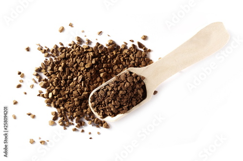 Instant coffee granules with wooden spoon, isolated on white background, top view