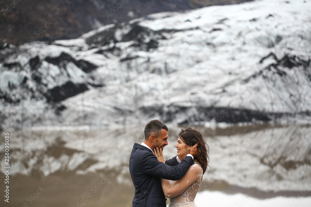 Beautiful wedding couple posing in snow