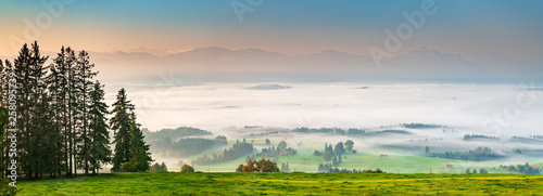 Panoramic View from Mt. Auerberg at Sunrise, Valley full of Fog, the Alps behind, Bavaria, Germany photo