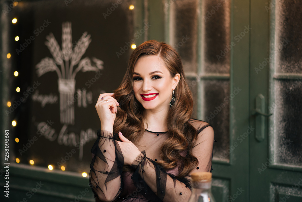 Portrait of a beautiful brunette with curls and red lipstick Portrait of a beautiful brunette with curls and red lipstick