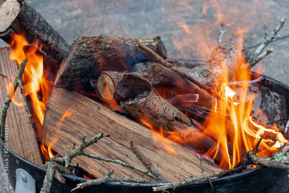 Campfire with orange flames on logs in an outdoor fire pit ~FIRESIDE~ Campfire with orange flames on logs in an outdoor fire pit ~FIRESIDE~