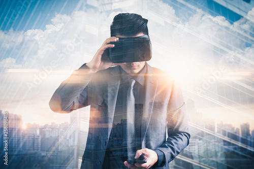 The abstract double exposure image of businessman using a smart glasses or vr glasses overlay with virtual hologram image. the concept of communication, internet of things and future life.