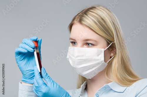 Fototapeta Naklejka Na Ścianę i Meble -  female doctor with blood sample in a test tube