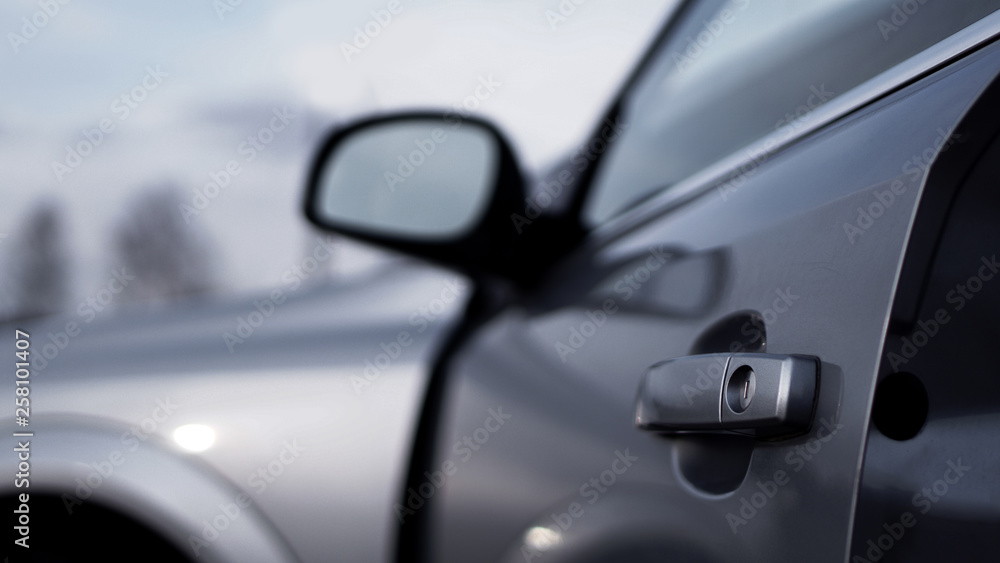 Color horizontal shot of closeup a dark silver car door handle