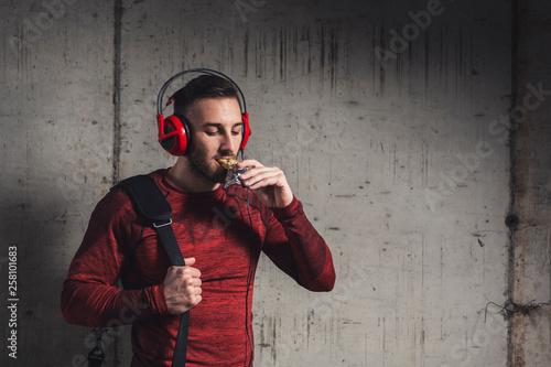 Athele eating protein bar photo