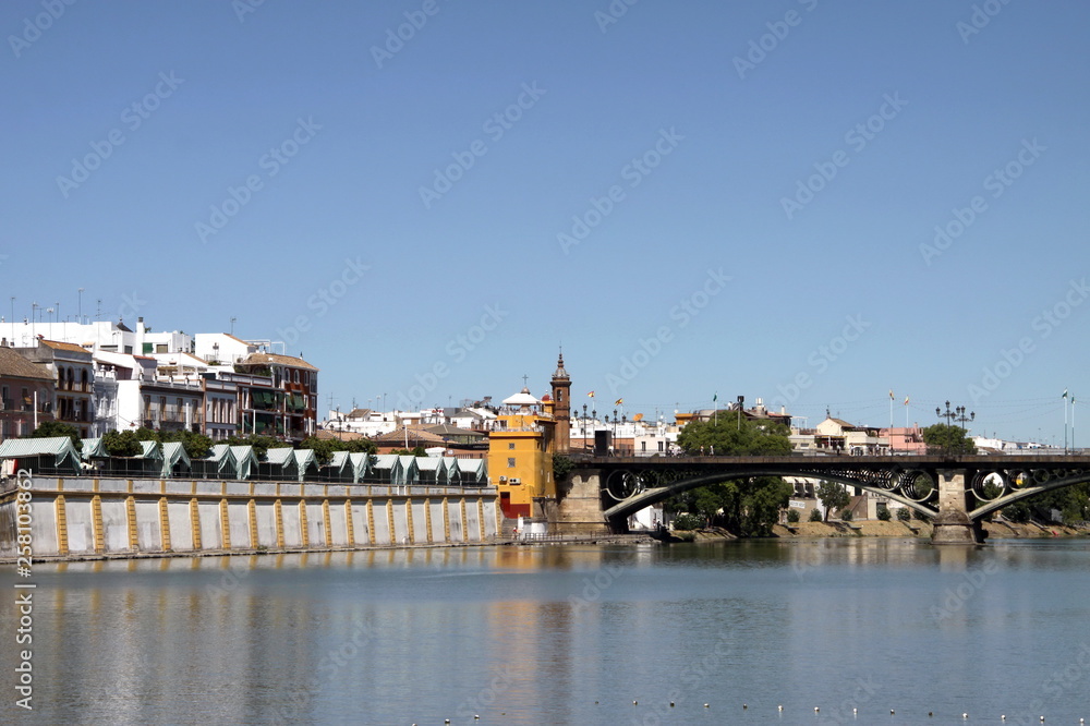 Obraz premium View of the Guadalquivir River and the Isabella II Bridge in Seville