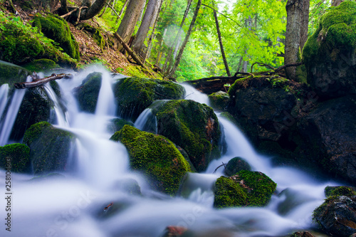 Mountain river in the Caucasus Mountains in the vicinity of Dombai Long exposure. Summer day.