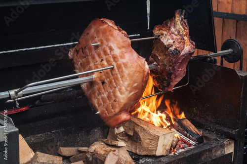 Large pieces of meat are roasted on fire photo