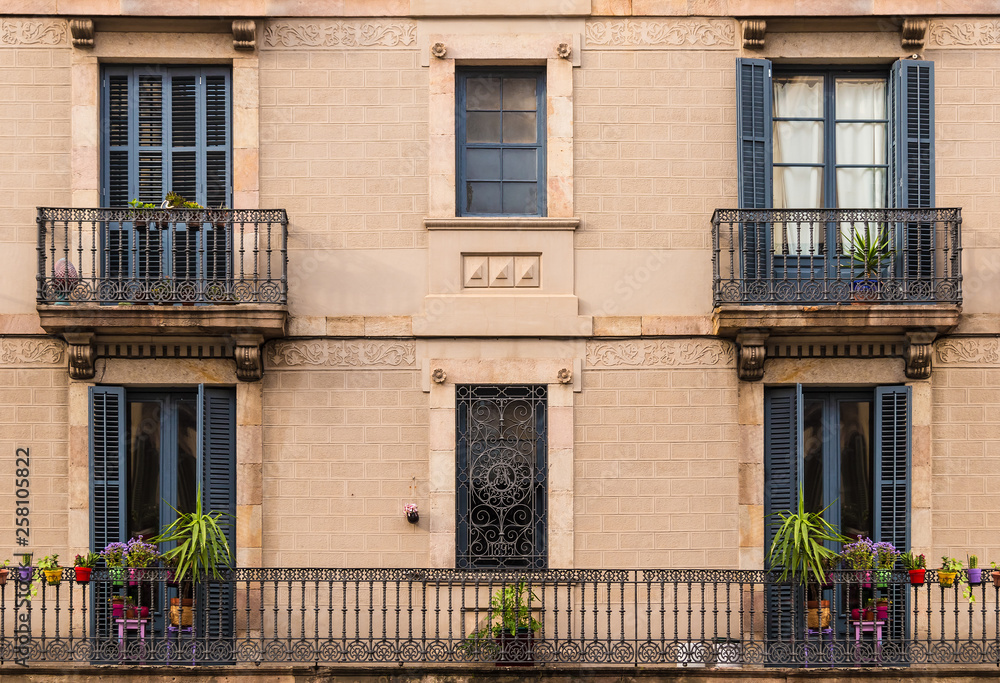 Several windows and balconies in a row on the facade of the urban historic building front view, Barcelona, Spain Several windows and balconies in a row on the facade of the urban historic building front view, Barcelona, Spain