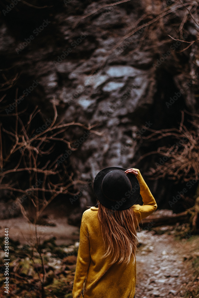 Young woman is walking through the cave system Rakov Skocjan in Slovenia