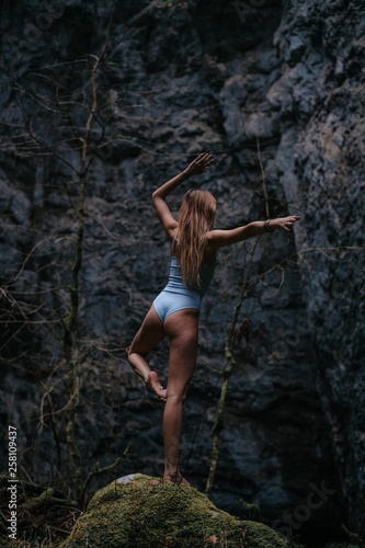 Wallpaper Mural Young woman is doing yoga the cave system Rakov Skocjan in Slovenia Torontodigital.ca