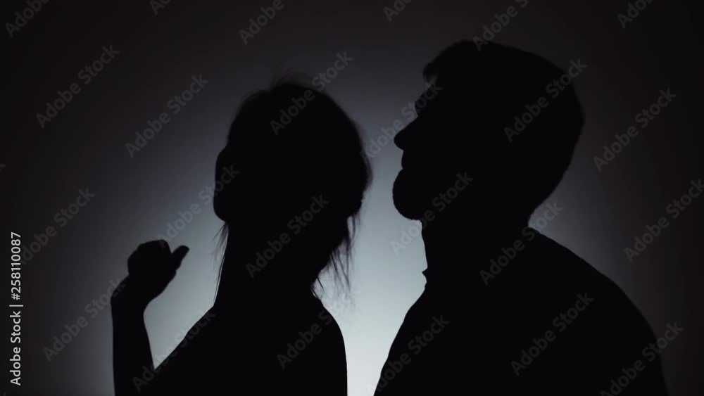 Silhouettes of man and woman. Shadows of men and women on a light background. A man and a woman are dancing together. Emotions, joint rest, dancers. Silhouettes of man and woman. Shadows of men and women on a light background. A man and a woman are dancing together. Emotions, joint rest, dancers.