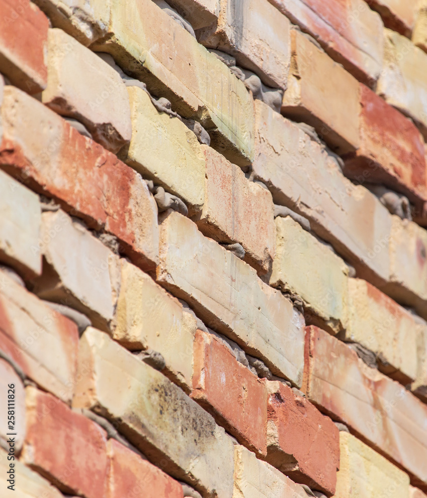 A wall of bricks in a house under construction as an abstract background A wall of bricks in a house under construction as an abstract background
