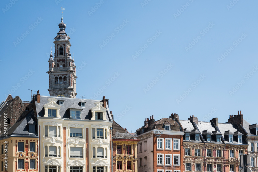 tower of Chamber of commerce, buildings at central town square in Lille, France. Against blue sky. space for text tower of Chamber of commerce, buildings at central town square in Lille, France. Against blue sky. space for text