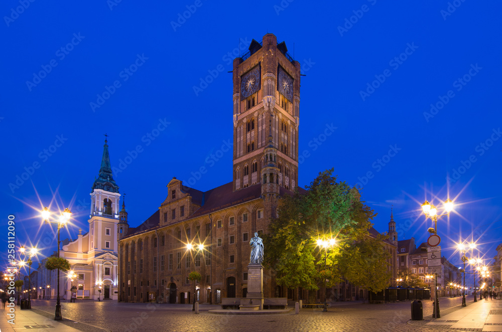 Historic city center in Torun. Statue of astronomer Nicolaus Copernicus and the Town Hall. Torun, Poland