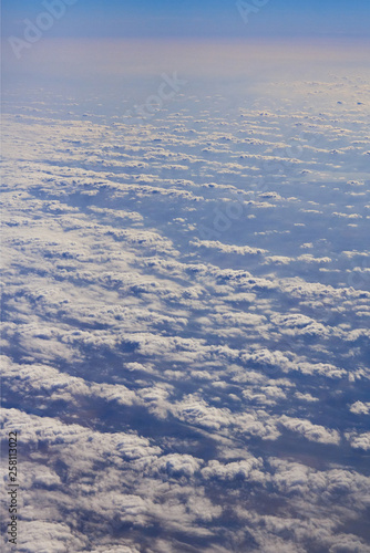 Photos of clouds from a height. Cloudy sky. Beautiful clouds in the blue sky. Clouds in clear weather. Sky texture The texture of the clouds. The texture of the earth. View of the ground from a height