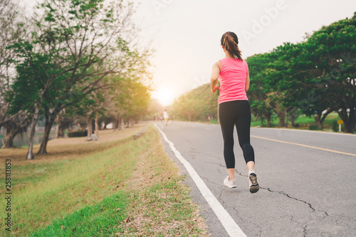 Healthy woman runner running exercise jogging on road, Woman fitness jog workout in the park during sunset
