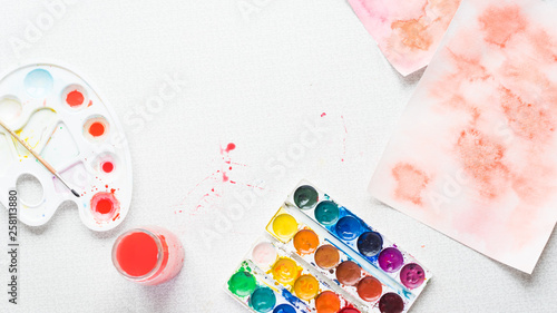 Photos Palette with paintbrush and watercolors, top view, horizontal