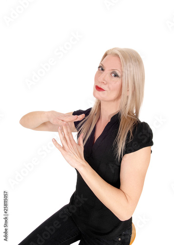 Blond woman making sign lets talk