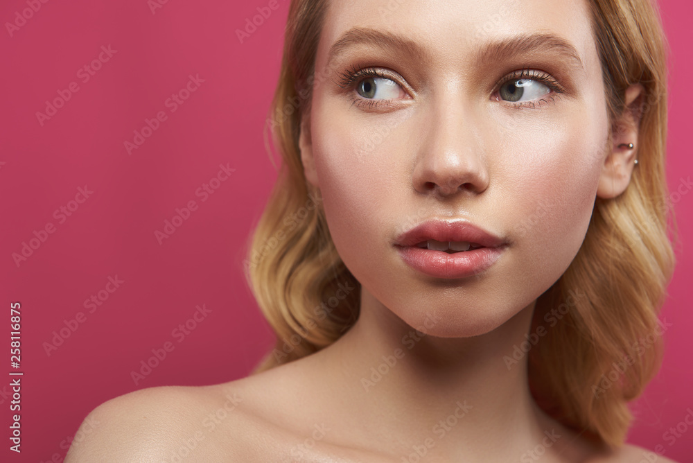 Pretty fair haired woman curiously looking aside Pretty fair haired woman curiously looking aside